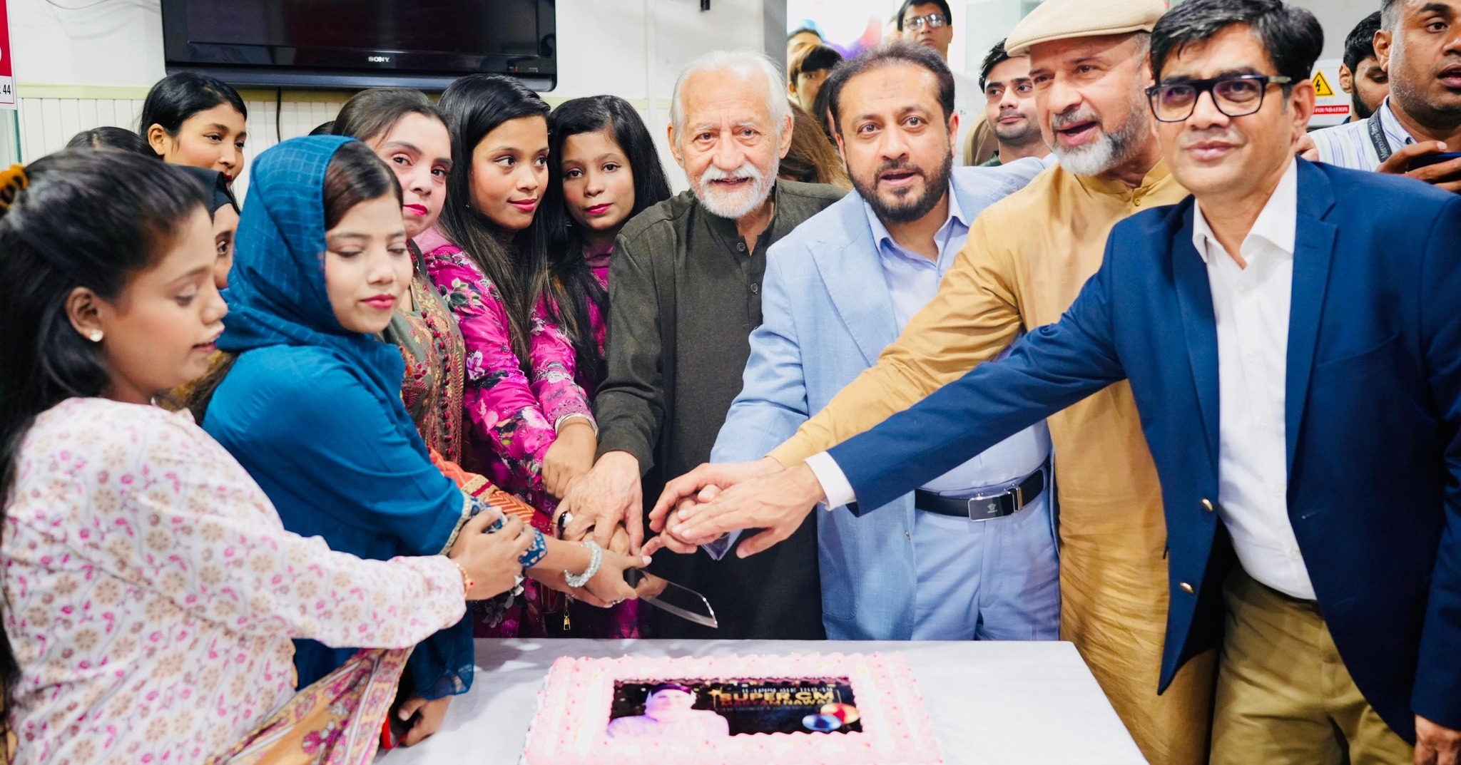 Khawaja Imran Nazir cutting birthday cake with children at Sundas Foundation on CM Maryam Nawaz Sharif’s birthday
